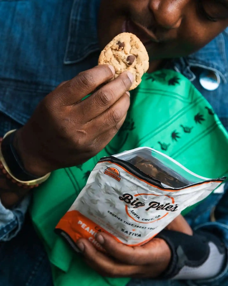 Someone takes a bite of a Big Pete's Treats cookie.