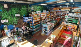 The interior of a grow shop with shelves full of hydroponic and outdoor gardening equipment.