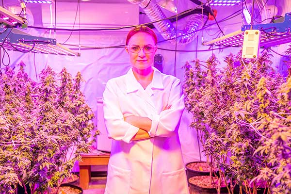 Woman standing in indoor grow